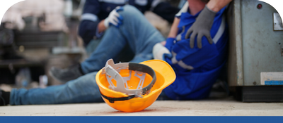 Employee injured on the job and hard hat on floor