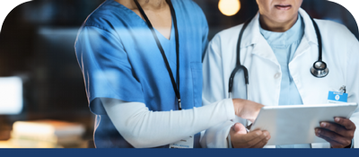 Healthcare workers collaborate using a tablet for medical planning and care